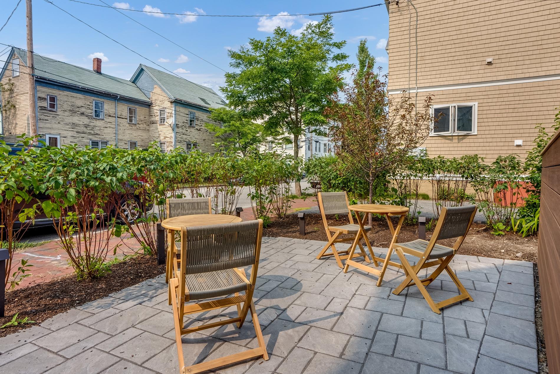 Shared patio with seating and garden beds