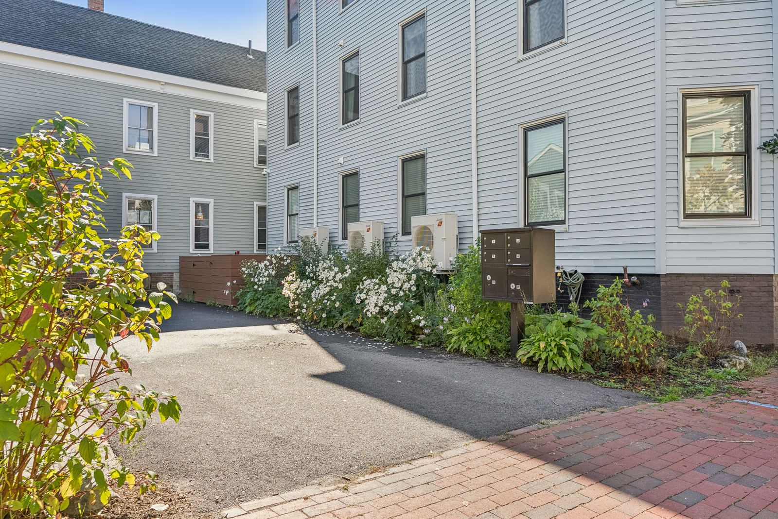 Walkway along the building with plantings