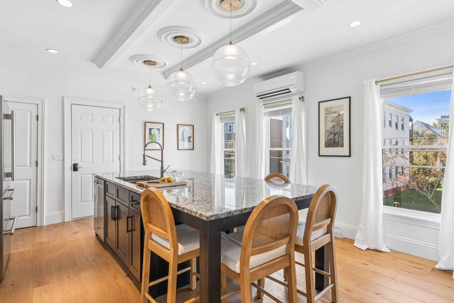 Kitchen island with seating beside the bay window, Residence One