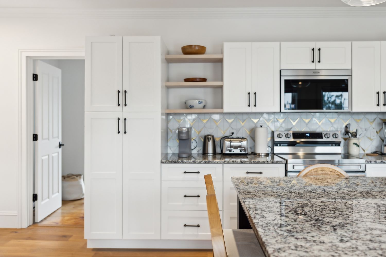 Kitchen with range, tile backsplash and open shelving, Residence One