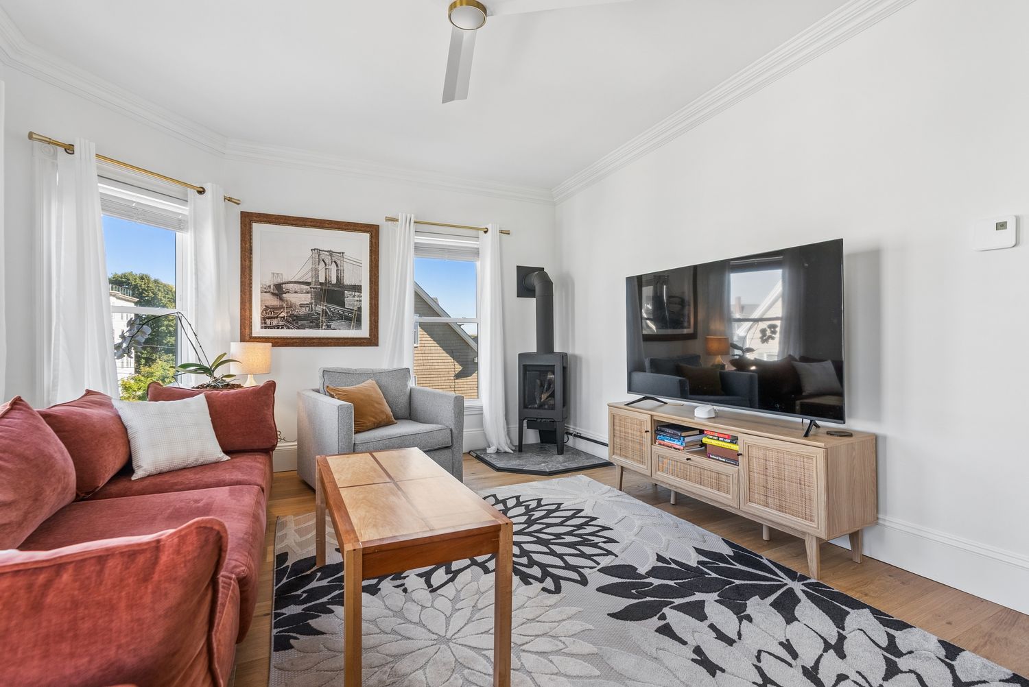 Living room with fireplace and television, Residence Three