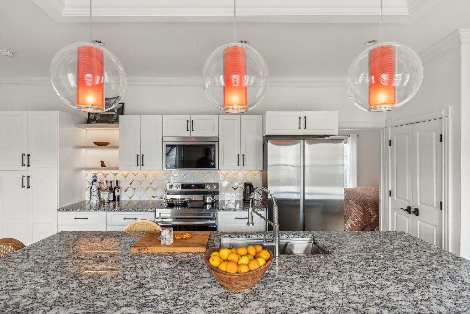 Kitchen with range, island and pendant lighting, Residence Three
